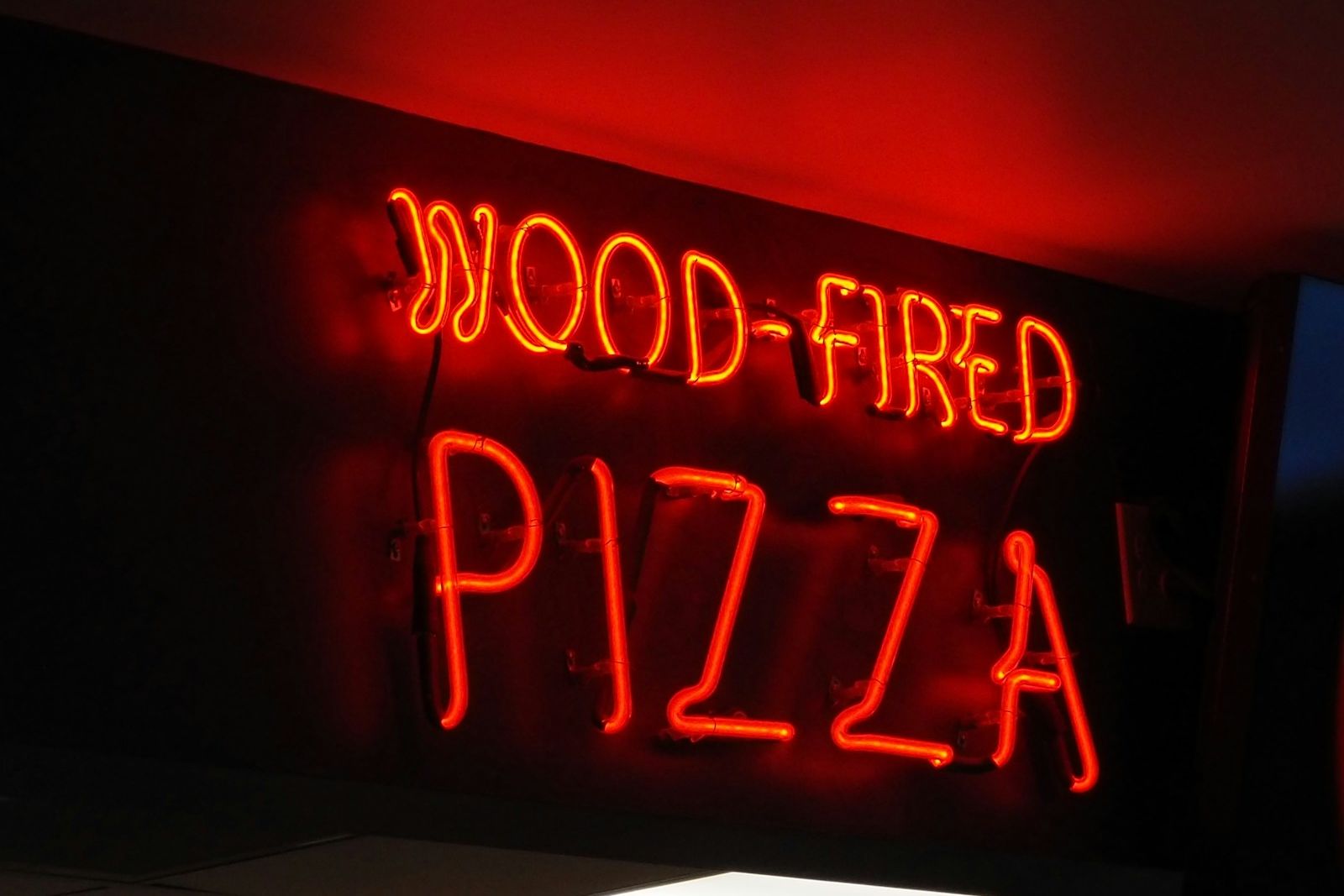 Fresh wood-fired pizza just pulled from the oven